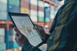 © LailaBee - Business Professional Analyzing Global Logistics Data on Tablet in Shipping Container Yard