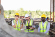 © JU.STOCKER - Group of Engineer team working on site, Foreman worker team with blueprints checking project at construction site