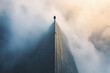 © Infinity Lens - Photograph of a Person at the Edge of a Skyscraper: A person standing on the edge of a tall skyscraper, looking down
