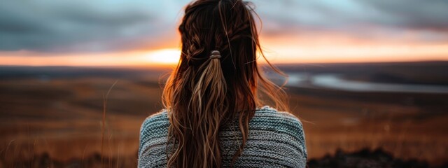 Canvas Print -  Woman's long haired head facing back, sunset behind