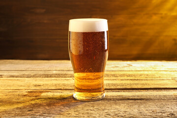 Wall Mural - Glass of beer with froth on wooden table