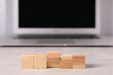 Sticker - Wooden cubes on light table against blurred background