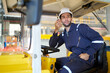 © offsuperphoto - Engineer or worker talking on walkie talkie and driving a car in the factory