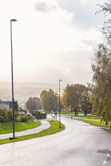 Poster - City street with a rain weather over city at autumn