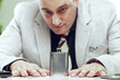 © Giulio_Fornasar - Businessman staring at flask on desk during work