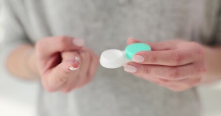 Poster - Soft contact lenses and a case in female hands