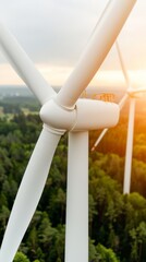 Wall Mural - close-up view of a modern wind turbine blade and tower against a green forest background during a golden sunset