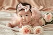 © Syahrul Zidane A - Cute Asia baby girl with a pink bow on her head, wearing a light rose dress laying down on a soft blanket