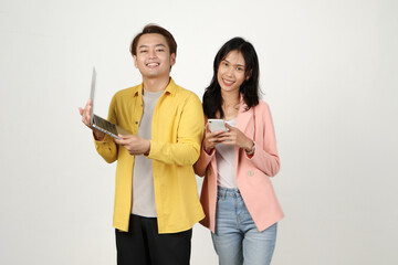 portrait of happy asian Indonesian couple holding laptop computer and phone on isolated background