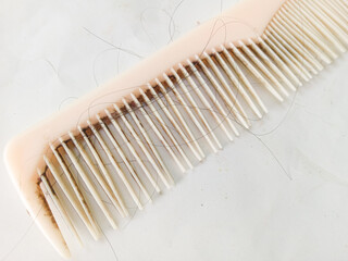 a dirty comb with falling hair isolated on white background. bad habits. hair problems. falling hair in comb