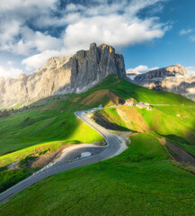 Wall Mural - aerial view of road in alpine mountains at sunset in summer