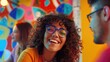 © Alexander Chaykin - A smiling woman with curly hair and glasses, a happy expression