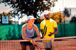 © Zoran Zeremski - Portrait of young couple on tennis clay court with racket during the day.