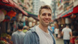 © VK Studio - A smiling man stands in a bustling market street, surrounded by vibrant shops and people, capturing the essence of urban life.