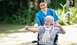 © Nuttapong punna - Asian physiotherapist helping elderly woman patient stretching arm during exercise correct with dumbbell in hand during training hand with patient Back problems in the garden.