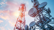 © VK Studio - Two large communication towers against a backdrop of a vibrant sunrise sky, symbolizing connectivity and technological advancement.