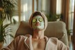 © ImronDesign - Adult man in bathrobe and towel turban enjoying spa day at home and relaxing in comfortable chair or armchair with facial beauty mask on face and fresh cucumber slices on eyes. Skin care concept , ai