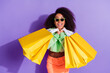 © deagreez - Photo portrait of young addicted american girl fashionista bring shopping bags purchase everything isolated on violet color background