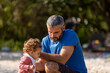 © marabelo - Young caucasian family having a picnic at the lake on a sunny afternoon.