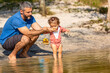 © marabelo - Young caucasian family having a picnic at the lake on a sunny afternoon.