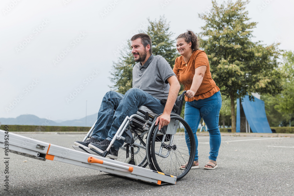 Order Man Ramp Assistant Female assistant helping a male person in wheelchair with transport ...
