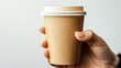 © overrust - hand holding a coffee to go cup on white background with copy space