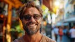 © PaulShlykov - A trendy man sporting sunglasses and a casual, yet fashionable outfit downtown.