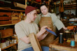 © AnnaStills - Male tailor showing done leather detail to his female intern with down syndrome