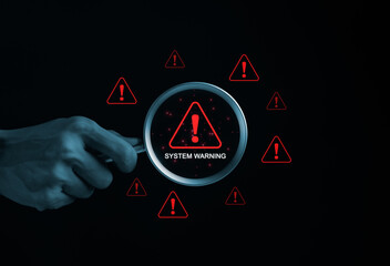 Wall Mural - System Warning Alert, Cyber Security Concept. Hand holds magnifying glass over digital warning sign with red exclamation marks, system warning or potential malicious cyber attack alert. Cybersecurity,