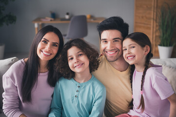 Sticker - Photo of positive good mood parents children dressed casual clothes smiling hugging indoors house apartment room