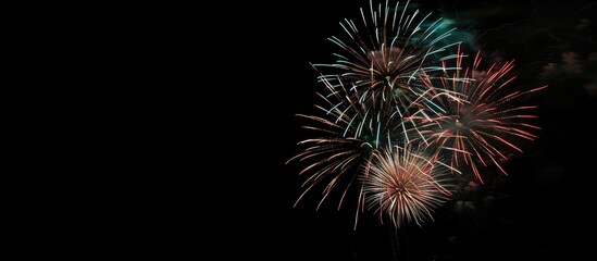 Poster - Colorful fireworks illuminating the night sky with a mesmerizing display creating a stunning visual effect against a dark background in a copy space image