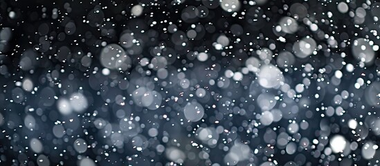 Poster - Selective focus enhances the beauty of falling snow against a black background in this nature oriented copy space image