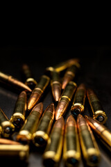 Canvas Print - Cartridges for rifle and carbine on a black. Bullet  on black background. Rifle bullets close-up on black back.