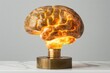 © Leo Rohmann - Golden brain with glowing light representing intelligence creativity and innovation in a modern design