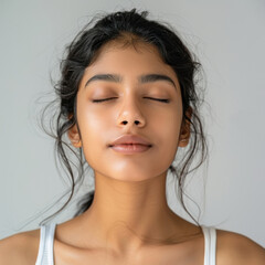 Wall Mural - young indian woman sitting on white background