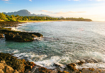 Wall Mural - Sunrise on The Rocky Volcanic Shoreline of Shipwreck Beach with Ha'upu Ridge In The Distance, Poipu, Kauai, USA