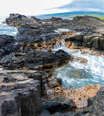 Wall Mural - Water Rushing Over The Lava SInks and Cliffs at Hokulia Shoreline Park, Hawaii Island, Hawaii, USA