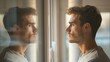© DigitalMagicVisions - Contemplative man with self-doubt staring at reflection in mirror, pondering mental health concerns