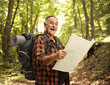© Ljupco Smokovski - Smiling mature hiker holding a map