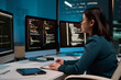 © Mediaphotos - Portrait of young woman as software developer writing code while using computer at office workplace in blue light copy space