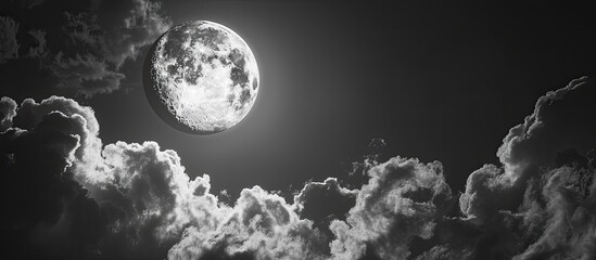 Wall Mural - the full moon is obscured by ominous clouds creating a mysterious ambiance in the sky with copy spac