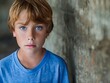 © VISUAL BACKGROUND - A young boy with blue eyes looking at the camera