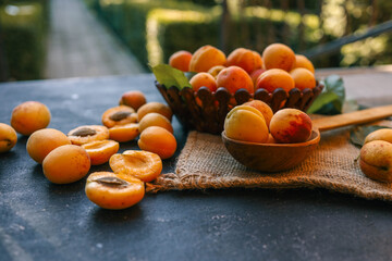 Wall Mural - Wooden spoon with apricots, concept of harvest and summer preserves