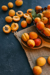 Wall Mural - Wooden spoon with apricots, concept of harvest and summer preserves