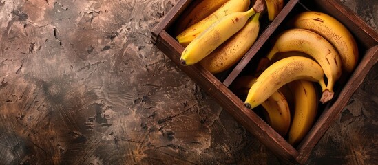 Sticker - A top view of fresh bananas displayed in a wooden box with free copy space image