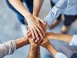© Pravinrus - Close up top view of young business people putting their hands together. Stack of hands. Unity and teamwork concept