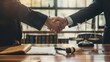 © Pravinrus - Professional Lawyer Handshake in Business Meeting with Scales of Justice and Gavel on Desk, Symbolizing Legal Agreement and Partnership