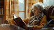 © drizzlingstarsstudio - an aged woman enjoying a quiet moment on her couch, deeply engaged in reading.