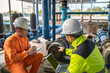 © reewungjunerr - Engineer and technician maintenance checking technical data of system equipment Condenser Water pump and pressure gauge,environmentalist working at water supply