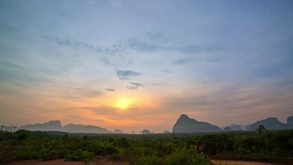 Fototapete - Time lapse wonderful morning colorful cloud in sunrise above Samed Nang Chee island Phang Nga viewpoint. 
amazing bright sky at sunrise. Beautiful sunrise tropical landscape background.